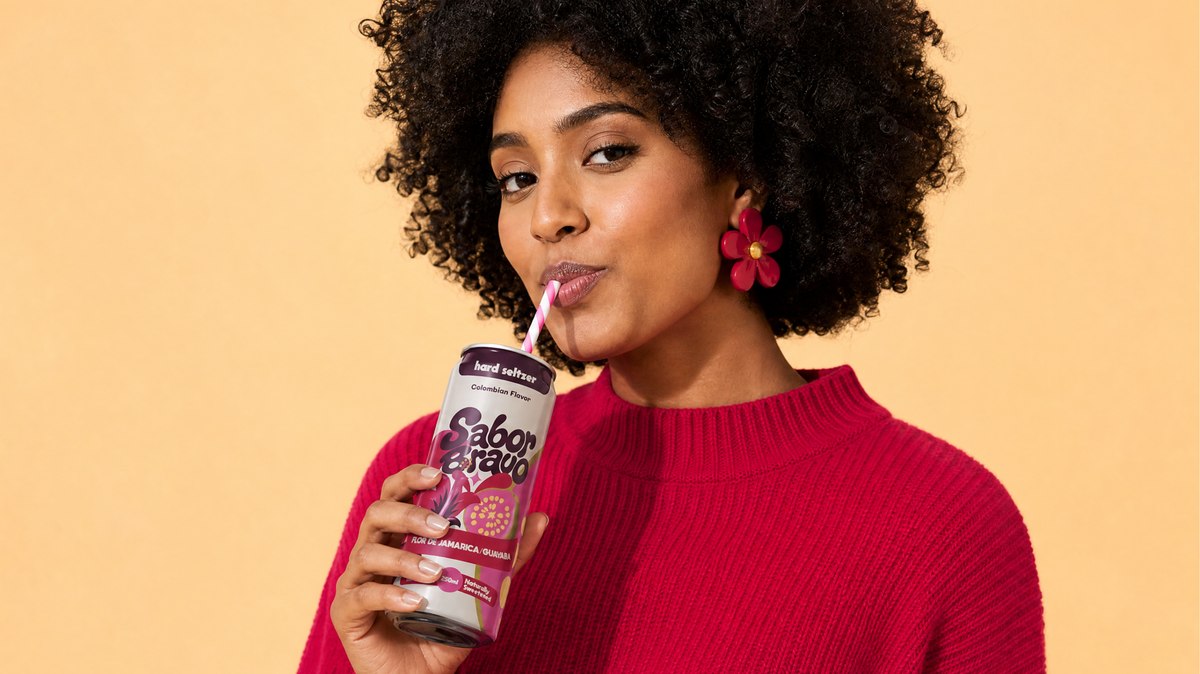Woman enjoying Sabor Bravo Guava + Hibiscus